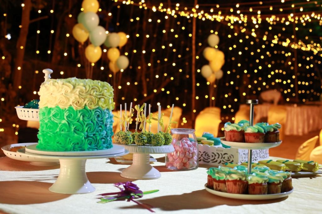 Host setting up a colorful, budget-friendly party with DIY decorations